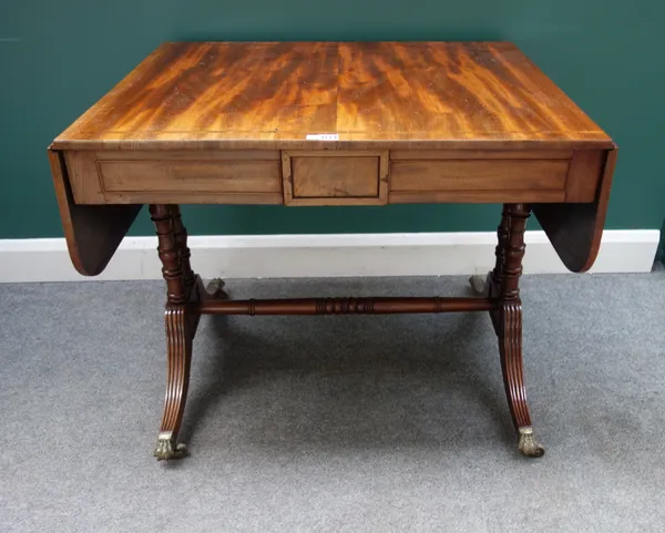 A Regency mahogany drop-flap side table, with three flush fit frieze drawers, on turned supports, 70cm deep x 90cm across, 142cm across when opened.
