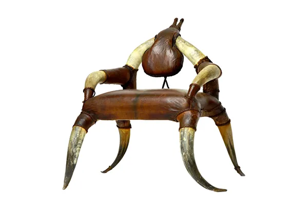 A late 19th/early 20th century horn open armchair, with tan leather upholstery, 93cm wide x 94cm high.  Illustrated