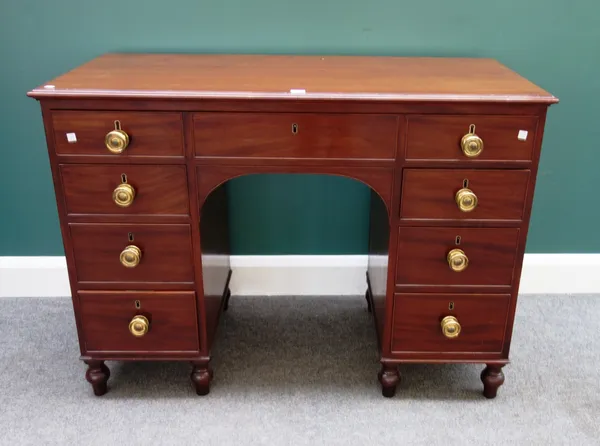A George III mahogany kneehole writing desk with seven frieze drawers, 116cm wide x 83cm high.