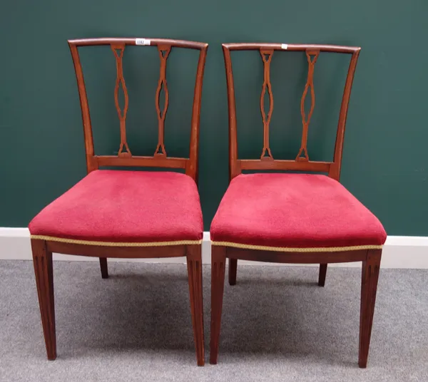 A pair of early 19th century Continental elm dining chairs, each with double panel splat on tapering square supports, 50cm wide x 92cm high, (2).