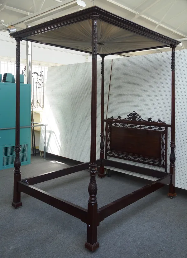 A late 19th century mahogany four poster bed, with pleated silk canopy, open fret carved headboard and carved and fluted columns, 177cm wide x 222cm l