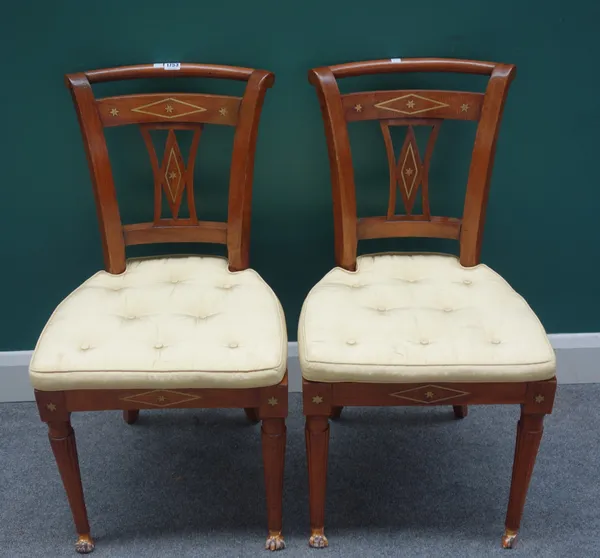 A pair of early 19th century Biedermeier brass inlaid walnut side chairs, on tapering fluted supports and gilt paw feet, each 46cm wide x 86cm high, (