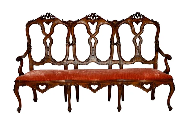 An 18th century style North Italian carved walnut salon suite, 19th century, to comprise; a sofa, 175cm wide x 110cm high, and four open armchairs, 65