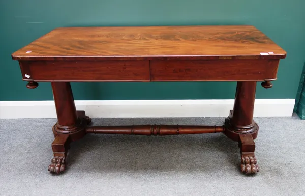 A mid-19th century mahogany two drawer centre/writing table on turned supports, 128cm wide x 65cm deep.