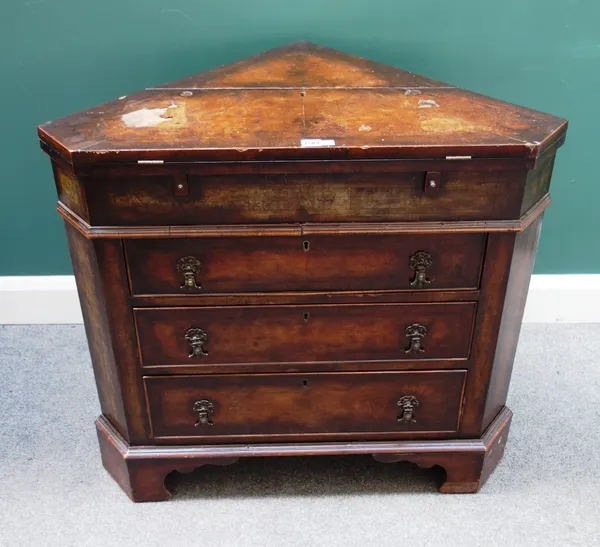 An 18th century style feather banded walnut corner bureau, the lift top enclosing fitted interior, over three drawers, on bracket feet, 87cm wide x 79