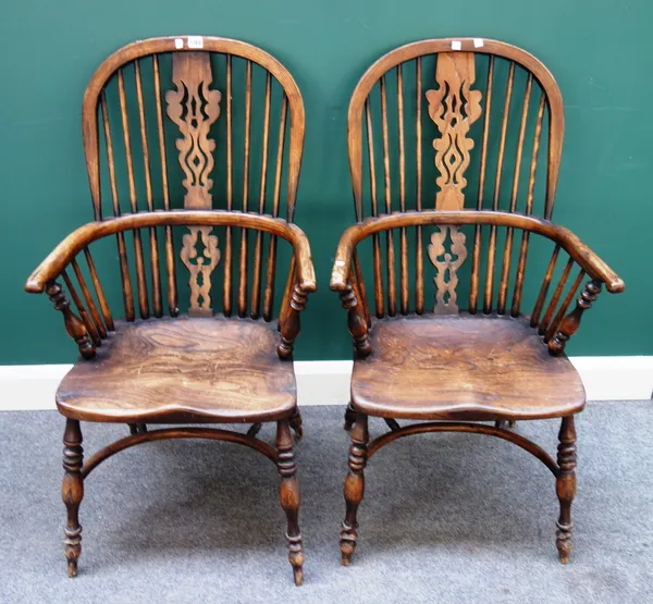 A pair of George III style elm and ash Windsor chairs, each with pierced splat and solid seat, on turned supports united by crinoline stretcher, 50cm
