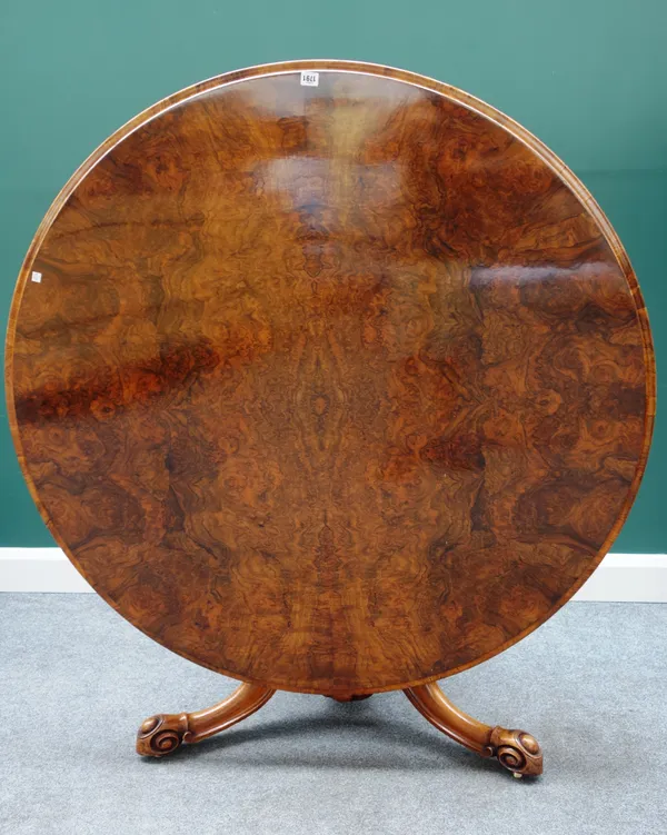A Victorian figured walnut circular snap top centre table on carved column and three down swept supports, 130cm diameter.