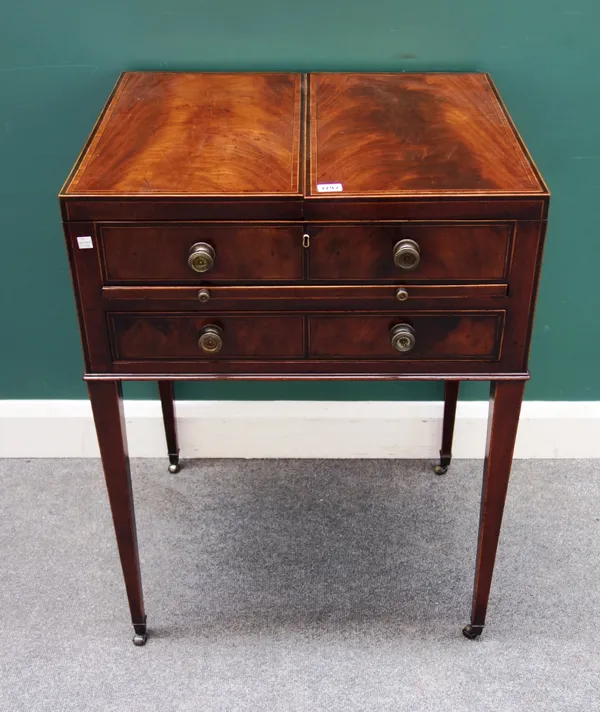 A George III inlaid mahogany gentleman's washstand, the double lift top enclosing a fitted interior, over one long drawer, on tapering square supports