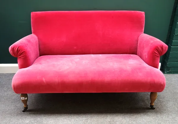 OKA;  A 20th century pink upholstered two seat sofa with roll over arms on turned oak supports, 140cm wide x 85cm high.