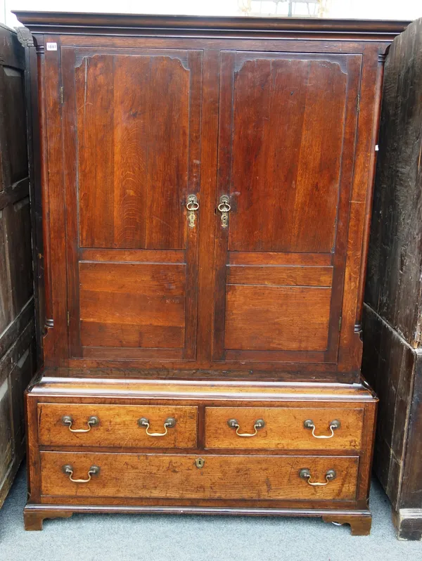 An 18th century Welsh oak press cupboard, with pair of panel doors over two short and one long drawer, on bracket feet, 130cm wide x 184cm high.