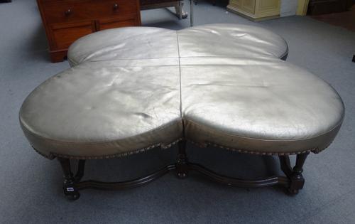 A large conversation stool, the quatrefoil top on eight baluster turned supports united by shaped stretcher, 150cm wide x 55cm high.