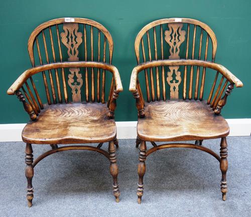 A pair of George III style elm and ash Windsor chairs, each with pierced splat and solid seat, on turned supports united by crinoline stretcher, 50cm