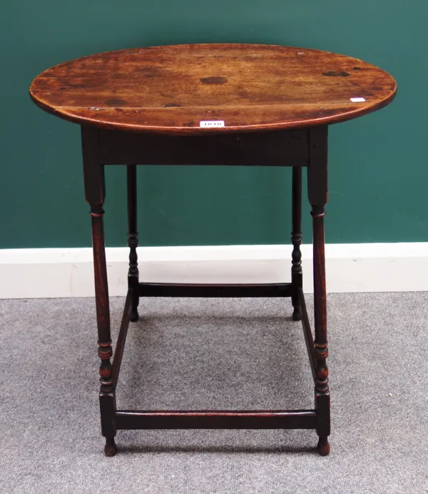 A made-up 18th century occasional table, the oval top on four slender turned supports united by perimeter stretcher, 59cm wide x 69cm high.