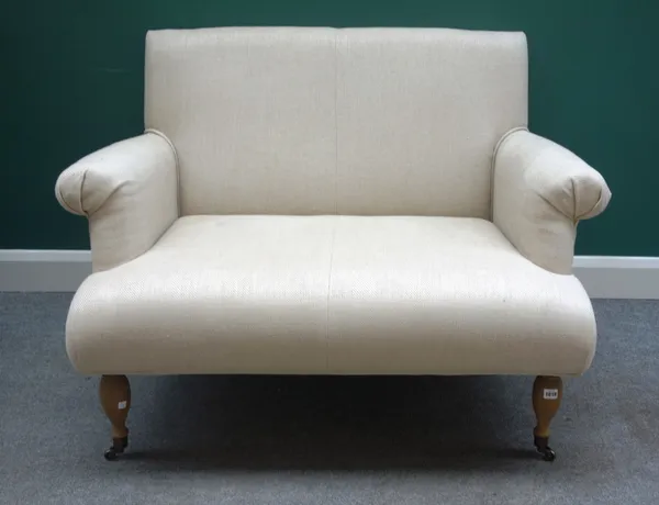 OKA; A 20th century cream upholstered two seat sofa, with roll over arms on turned supports, 110cm wide x 86cm high.