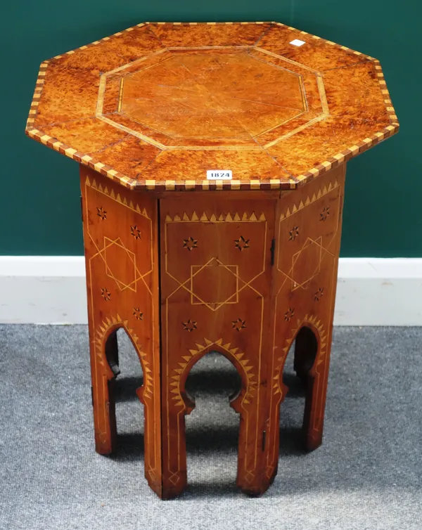 An early 20th century Ottoman style inlaid burr yew octagonal occasional table, on Islamic arched carved base, 51cm wide x 62cm high.