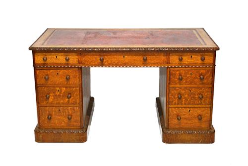 Edwards & Roberts; a Victorian oak pedestal desk with nine drawers about the knee, on plinth base, 137cm wide x 73cm deep.  Illustrated