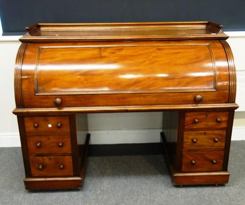 A Victorian mahogany roll top pedestal desk, the pull-out fitted interior over six drawers about the knee, 153cm wide x 117cm high.