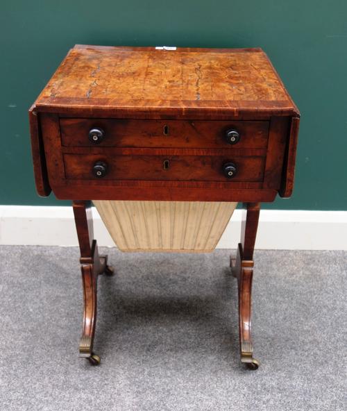 A Regency figured yew drop flap work table, with a pair of frieze drawers over pull-out wool box, on trestle end standards, 46cm deep x 50cm across x