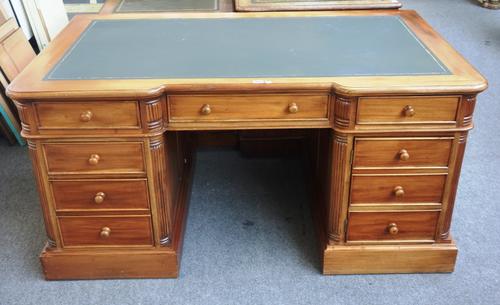 A mahogany inverted breakfront pedestal desk of 18th century design, with three frieze drawers, one pedestal with pair of drawers and the other with c