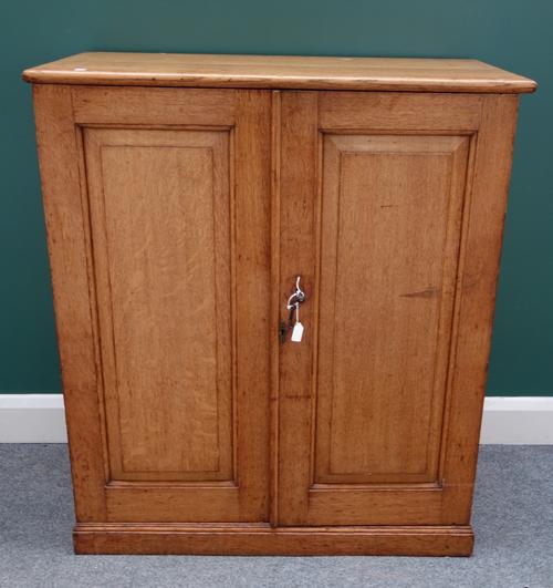 A 19th oak side cupboard, the pair of panelled doors enclosing a fitted interior on a plinth base, 92cm wide x 107cm high.