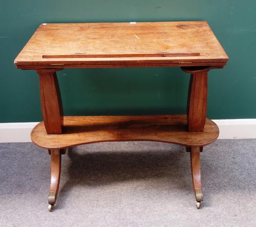 A George III mahogany free-standing reading/drafts table, with angle and height adjustable top united by kidney shaped undertier, on four splayed supp