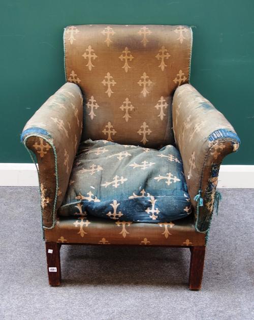 An Arts and Crafts oak framed armchair, with roll out arms, on square supports united by double stretcher, 77cm wide x 94cm high.