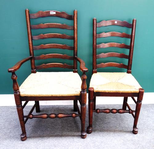 A set of eight 18th century style Lancashire ladder back dining chairs, with wavy splat on turned supports, to include a pair of carvers, (8).