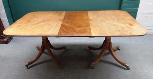 A George III style mahogany extending pedestal dining table, on eight downswept supports, to include one extra leaf, 106cm wide x 142cm long, 182cm lo