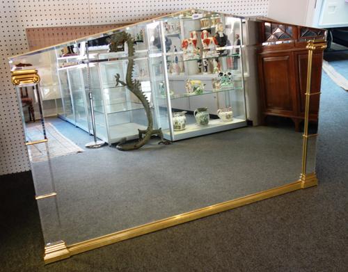 A A Hollywood Regency style architectural arch top parcel gilt metal bevelled glass wall mirror, 163cm wide x 110cm high.