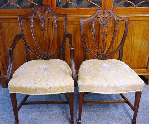 A set of eight 19th century mahogany framed shield back dining chairs, with bow seats on tapering square supports, to include a pair of carvers, (8).