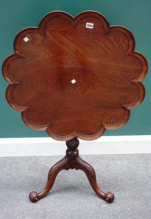A 19th century mahogany snap-top occasional table, with lobed circular top, on a carved 18th century tripod base, 71cm wide.