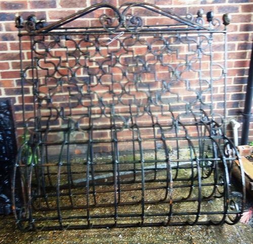 A set of three 19th century black painted iron balcony fronts, each with interlocking quatrefoil and bow base, each 137cm wide x 151cm high, (3).