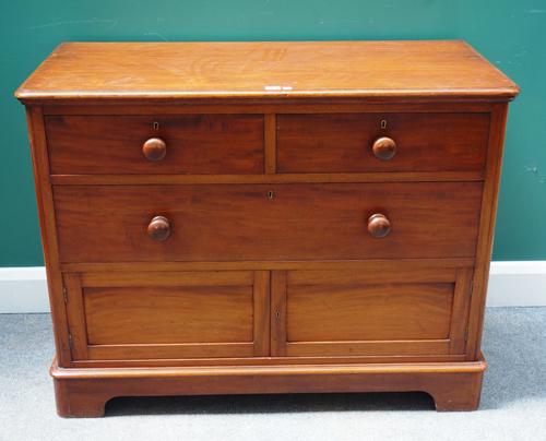 An unusual 19th mahogany chest, with two short over one long drawer and pair of panelled cupboards, on bracket feet, 107cm wide x 82cm high.