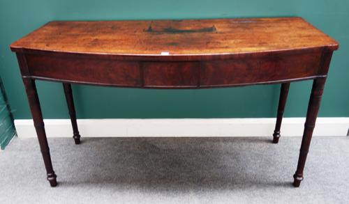 An early 19th century mahogany bowfront serving table, on ring turned supports, 153cm wide x 87cm high.