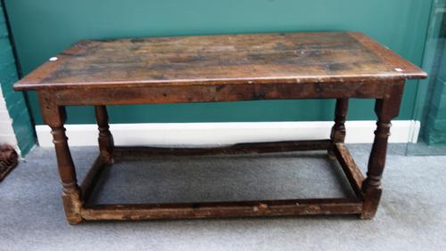 A Charles II and later oak refectory table, the cleated plank top on four turned supports on perimeter stretcher, 77cm wide x 155cm long.