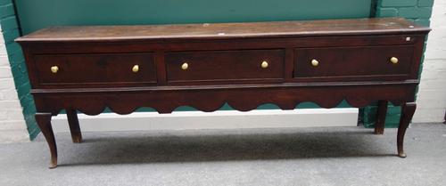 A mid-18th century oak dresser base, with three frieze drawers over wavy frieze on cabriole supports, 236cm wide x 83cm high.