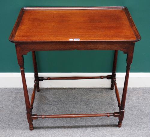 A George III silver table, the dished rectangular mahogany top over four turned oak supports, 71cm wide x 72cm high.