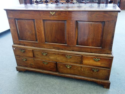 A made-up 18th century chest, with lift top over triple panel front and five various drawers, 159cm wide x 115cm high