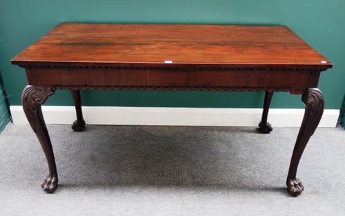 A George II Irish style mahogany serving table, the rectangular top over gadrooned frieze on acanthus capped club supports and hairy paw and ball feet