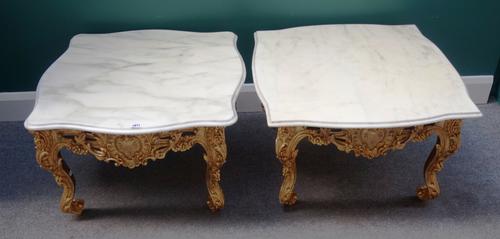 A near pair of 18th century style coffee tables, each with serpentine marble top over carved and pierced gilt base, on scroll supports, approximately