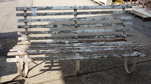 An early 20th century white painted wrought iron garden bench, with slatted seat, 181cm wide x 89cm high.