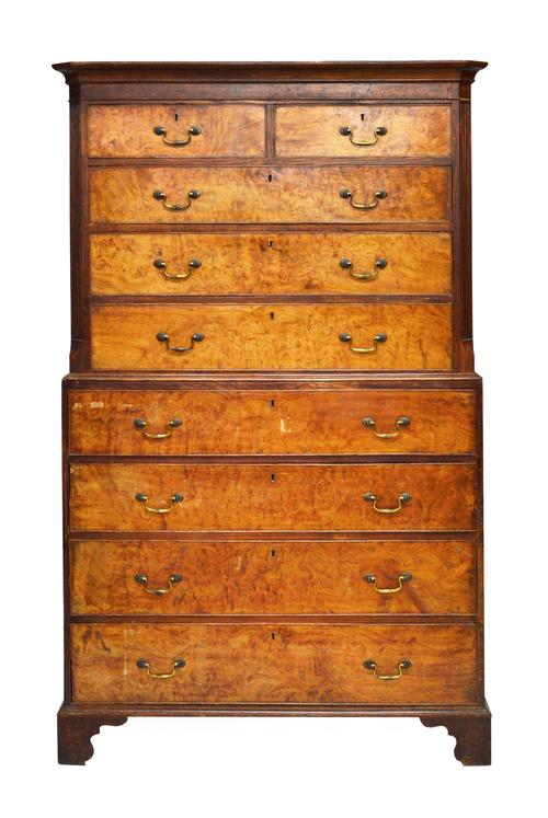 A mid-18th century solid elm chest-on-chest, the upper section with two short over three long graduated drawers, flanked by canted fluted corners, the