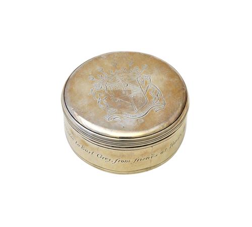 A George III silver box and cover, of circular form, the cover engraved with a coat of arms and a motto, engraved to the side, Presented to Earl Grey,