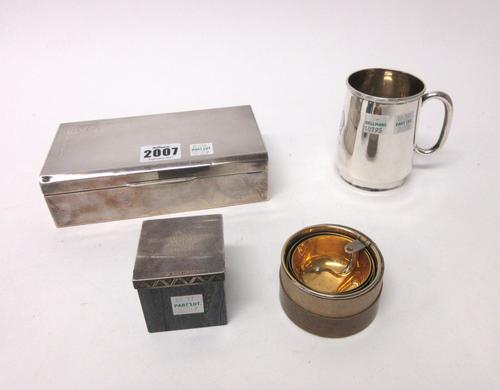 A silver rectangular table cigarette box, wooden lined within, the hinged lid with engine turned decoration, Sheffield 1950, a christening mug, Sheffi