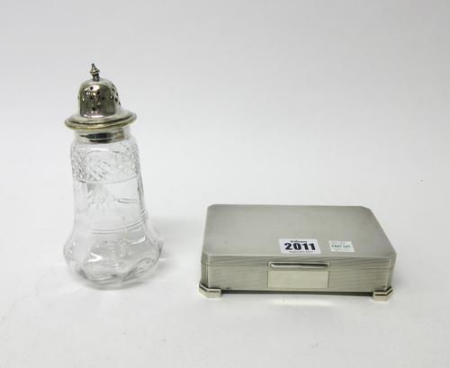 A silver rectangular table cigarette box, the exterior engine turned in an Art Deco inspired design, raised on four feet, London 1961 and a silver pla