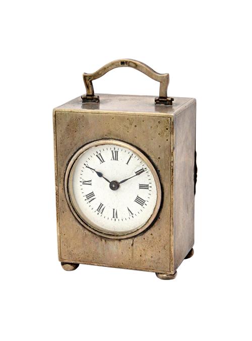 A silver rectangular cased carriage clock timepiece, the circular enamelled dial with black Roman numerals, the case with engine turned decoration, wi