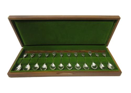 A set of twelve silver teaspoons, with the original fitted wooden case and paperwork, detailed The Royal Horticultural Society Flower Spoons, length o