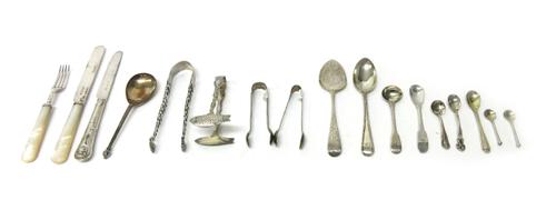 Silver flatware, comprising; three pairs of sugar tongs, a pair of sardine tongs, a spoon detailed The Writhen Spoon to the accompanying card, with a