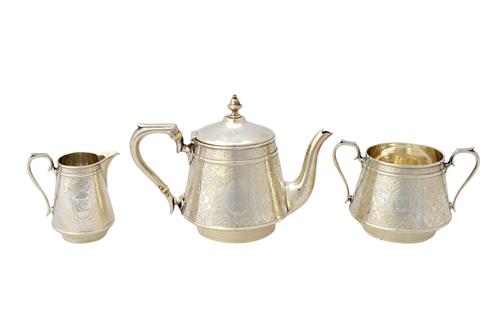 A Victorian silver three piece tea set, comprising; a teapot, a twin handled sugar bowl and a milk jug, each piece of tapering cylindrical form, havin