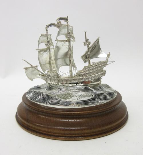 A silver limited edition model of The Golden Hind, in sail at sea, mounted to an oak base, modern.